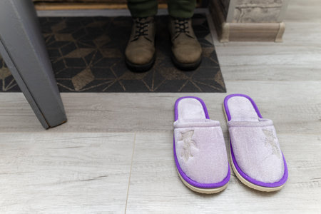 home slippers stand near the threshold of the house. slippers on the doorstep. man returned home. high quality photoの写真素材