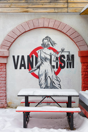 Moscow, Russia - February 20, 2023: vandalism writing on the wall. street cafe in winterのeditorial素材