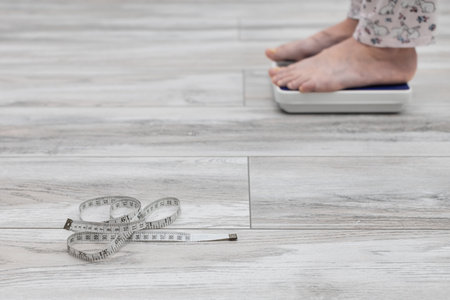 measuring tape taken with a shallow depth of field. measuring tape lies on the scales. personal...