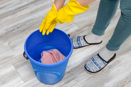 man puts on gloves before cleaning the room. house cleaning with glovesの写真素材