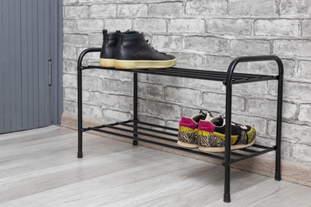 shoe rack with shoes stands in the hallway of the house. shoe rack with shoesの写真素材