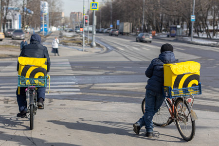 Moscow, Russia - March 20, 2023: bike food delivery man. delivery man on the city street. delivery service. high quality photoのeditorial素材