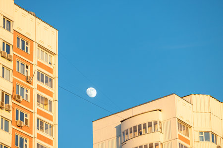 Moscow, Russia - May 01, 2023: moon in the sky between houses. rising moon in the skyのeditorial素材