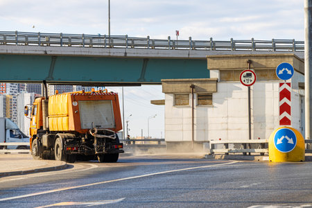 Moscow, Russia - April 18, 2023: sweeper in the city. heavy transport in the city. road sign on the carriageway for heavy vehicles.のeditorial素材