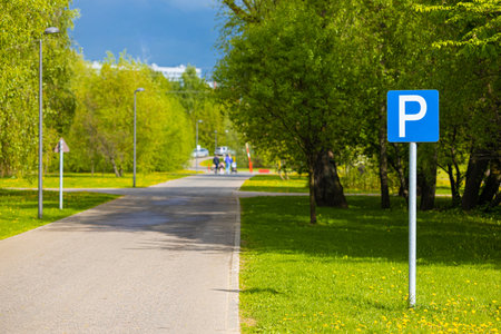 parking area in city park in summer. parking sign in the park. empty parkingの写真素材