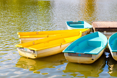 boats of different colors stand on the pier. empty boat at the pierの写真素材