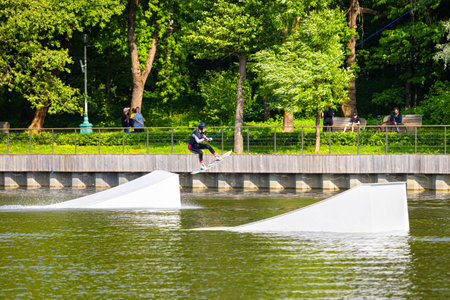 Moscow, Russia - June 02, 2023: girl wakeboarding in the park. girl jumping from a trampoline on a wakeboardのeditorial素材