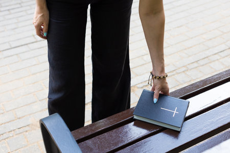 A woman found someone's lost bible on a park bench. man found bible. Bible on the bench