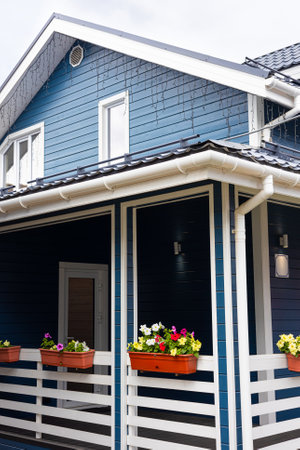 pallet with flowers on the veranda of the house. home decoration with flowersの写真素材