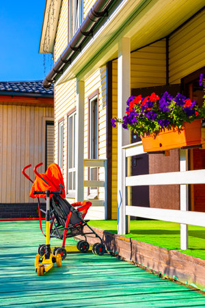 empty baby carriage stands on the porch of the house. children visit their parents. High quality photoの写真素材