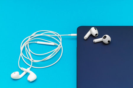 white wireless headphones lie on a laptop. connecting headphones to laptop. Wireless headphones provide greater comfort than wired ones. High quality photoの写真素材