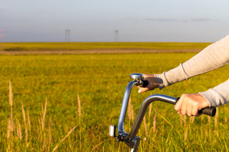 girl riding a bike on a country road. woman riding a bike on an empty road. high quality photoの写真素材