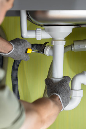 Repairing a pipe in the kitchen under the sink. kitchen plumbing repairs. connecting the washing...