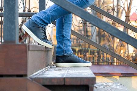 man going down the wooden steps of the stairs. wooden staircase. High quality photo