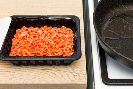 packaging with minced meat in the kitchen. chopped meat raw minced meat. fried minced meat