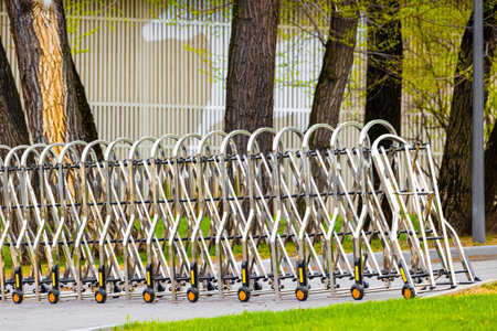 sliding barrier on wheels in unfolded position. sliding barrier on wheels on the street. extended...