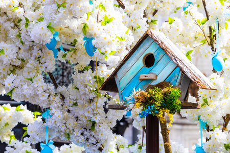 wooden birdhouse on the Easter tree, close-up. tree with easter eggs. outdoor easter decorationの写真素材
