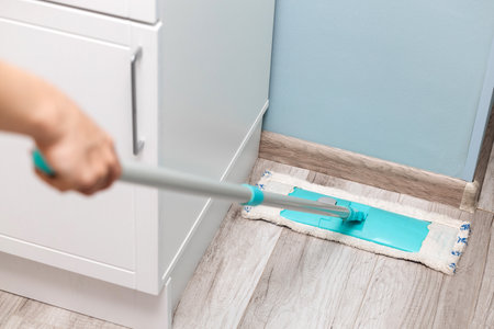 housewife wiping the floor with a dry mop. house cleaning from first person view. dry floor...