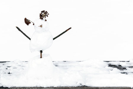 funny snowman on white background, close-up. snowman made of tree branches and leaves. High quality photoの写真素材