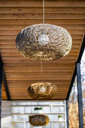 lamp with wicker shade. unusual lamp. hanging lamp. Vertical photoの写真素材