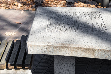 stone backgammon table, close-up, no people. backgammon table in the park. stone countertop