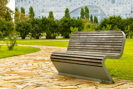 empty curved park bench, close-up. unusual bench a place to relax in the parkの写真素材