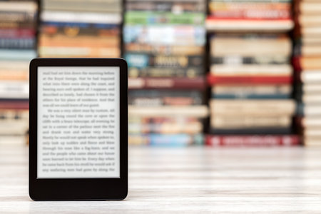 An e-book against the background of a hardcover book. image of an e-book with space for inscription....