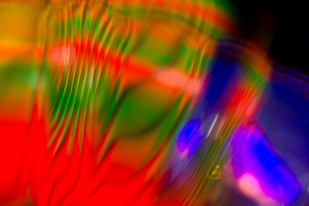 Abstract colored background and blurred spots of light from the center.