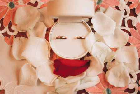 luxury wedding rings with stylish decoration near them.