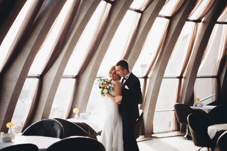 wedding couple standing in hotel.の写真素材