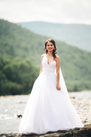 bride on a background of the river and mountainsの写真素材