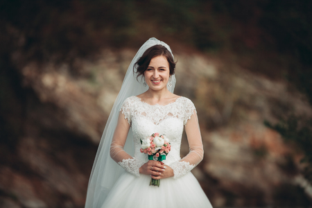 Girl, model, bride on a background of the river and mountains. Beauty portrait.の写真素材