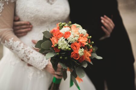 Pretty good wedding bouquet of various flowers in hand.の写真素材