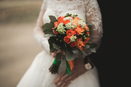 Pretty good wedding bouquet of various flowers in hand.の写真素材