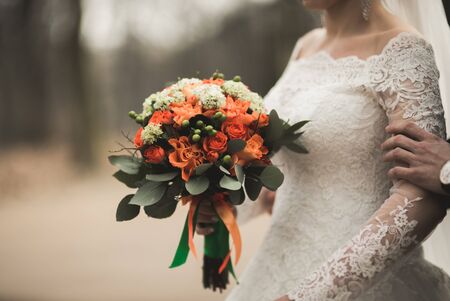 Pretty good wedding bouquet of various flowers in hand.の写真素材