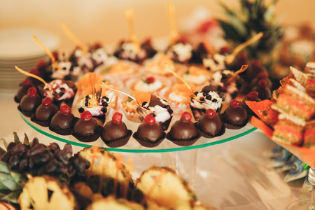 Different delicious desserts and cakes on the buffet table.の写真素材