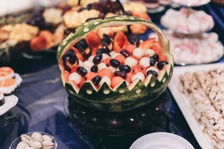 Various sweet sliced fruit on a buffet table.の写真素材