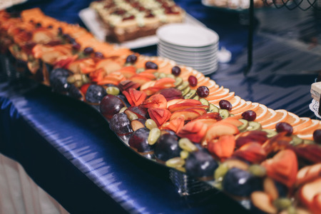 Various sweet sliced fruit on a buffet table.の写真素材