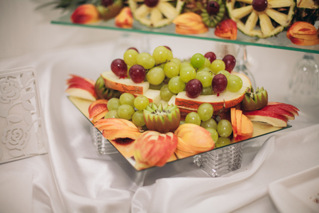 Various sweet sliced fruit on a buffet table.の写真素材