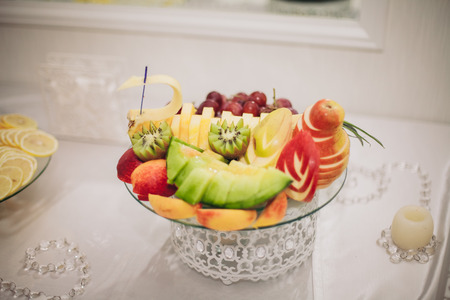 Various sweet sliced fruit on a buffet table.の写真素材