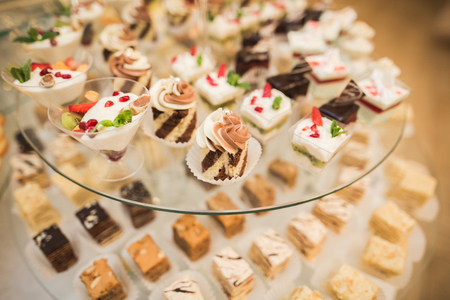 Different delicious desserts and cakes on the buffet table.の写真素材