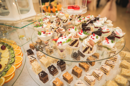 Different delicious desserts and cakes on the buffet table.の写真素材