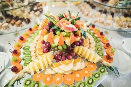 Various sweet sliced fruit on a buffet table.の写真素材