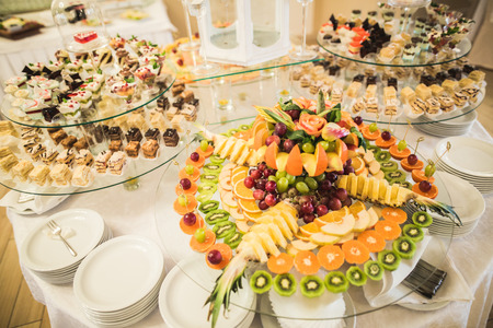 Various sweet sliced fruit on a buffet table.の写真素材