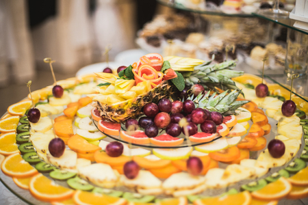 Various sweet sliced fruit on a buffet table.の写真素材