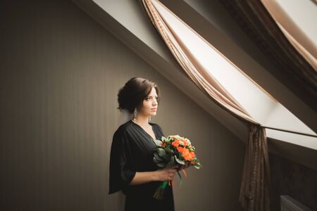 Luxury bride in black robe posing while preparing for the wedding ceremony.の写真素材