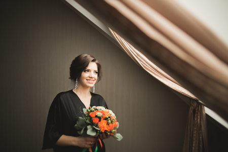 Luxury bride in black robe posing while preparing for the wedding ceremony.の写真素材