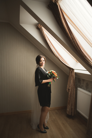 Luxury bride in black robe posing while preparing for the wedding ceremony.の写真素材