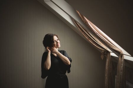 Luxury bride in black robe posing while preparing for the wedding ceremony.の写真素材