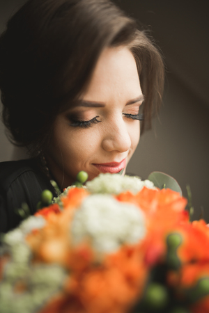 Luxury bride in black robe posing while preparing for the wedding ceremony.の写真素材
